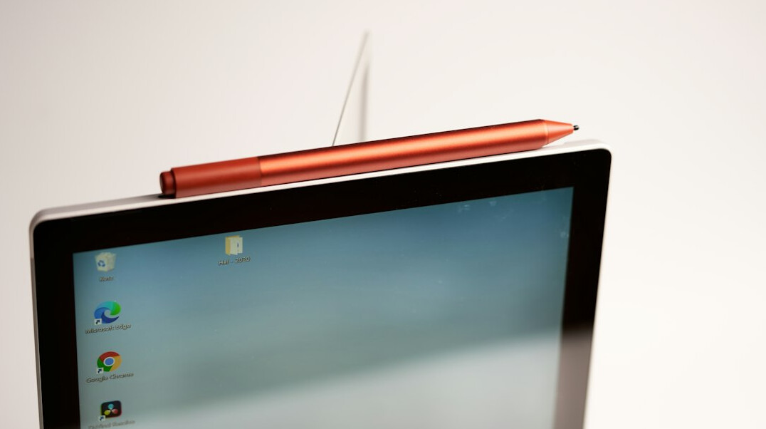 Hand writing in a notebook on a desk